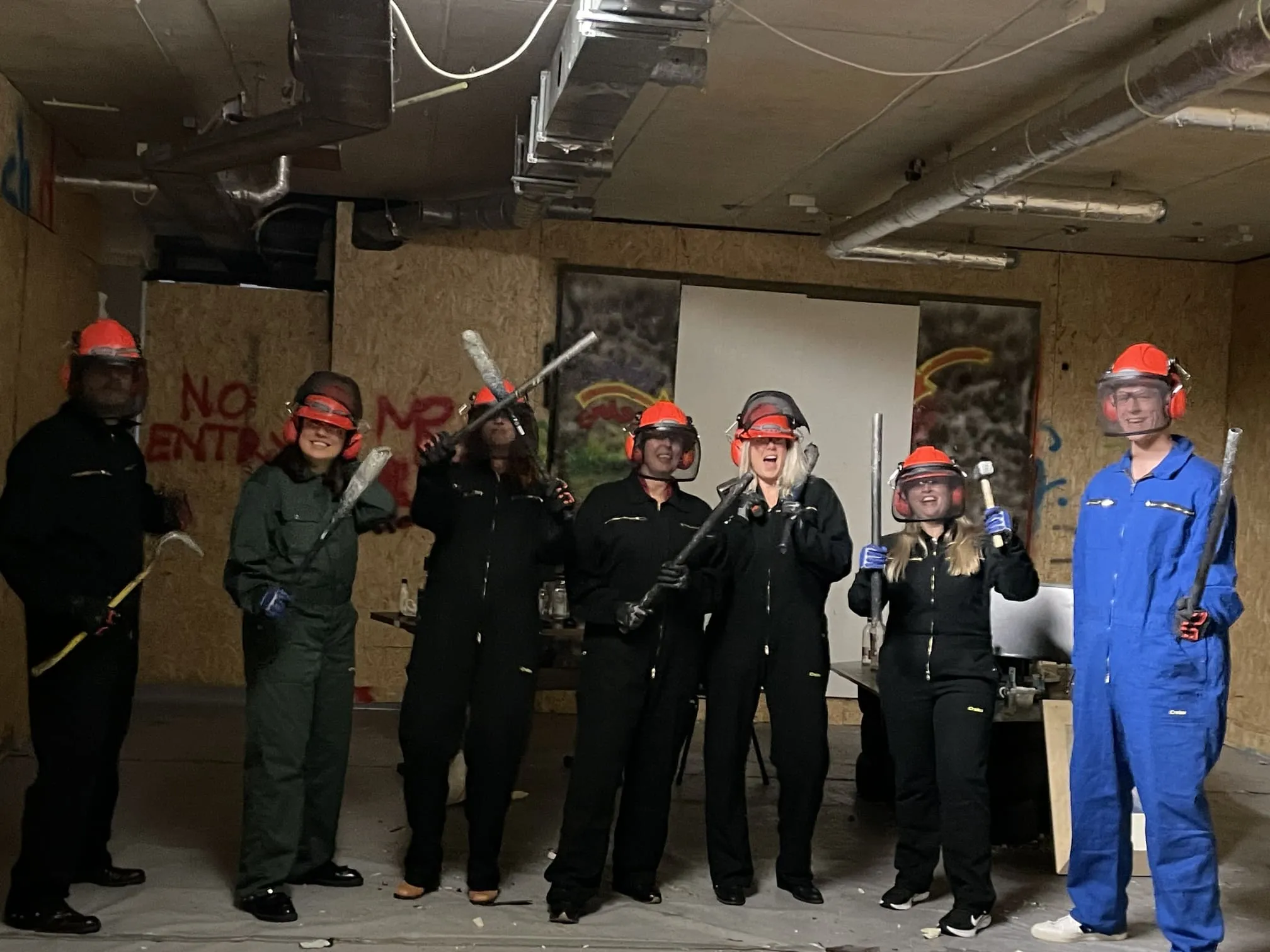 Team in protective gear ready for a team building session at The Rage Room